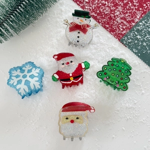 Set of 5 Christmas hair clips featuring snowman and Santa shapes with glitter finish