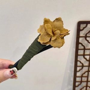 Vintage mustard yellow floral hair claw clip with olive green base in hand display