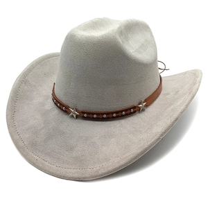 Detail of suede cowboy hat featuring brown leather band with silver stars and rivets