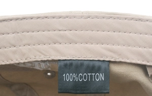 Close-up of the 100% cotton inner label and high-quality stitching on the khaki baseball cap