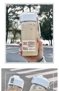 Close-up of portable water bottle featuring one-hand push button lid and carrying handle