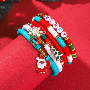 Detailed view of five-piece Christmas beaded bracelet set with holiday themed charms