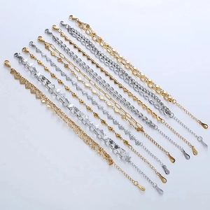 Set of eleven geometric gold and silver chain bracelets with heart and triangle charms