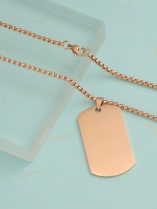 Rose gold rectangle military dog tag pendant on a matching box chain over marble background