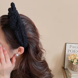 Plush bow headband in black teddy fleece fabric for a stylish high skull top winter look