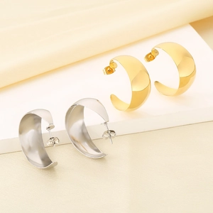 Polished C-shaped wide hoop earrings in gold and silver finishes on display stand
