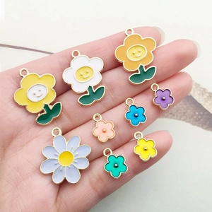Macro view of colorful enamel alloy flower pendants for DIY jewelry making and crafts