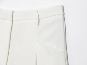 Détail de la taille et des poches sur ce pantalon blanc plissé pour femme