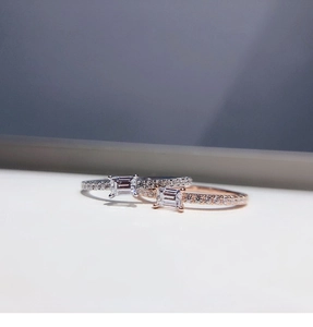 Detail of silver and rose gold baguette-cut rings with pavé setting and sparkling stones