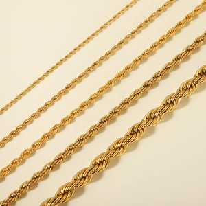 Detailed view of four golden stainless steel rope chains in various thicknesses