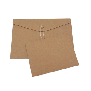 Detail of a brown kraft paper envelope with a classic string and washer closure design