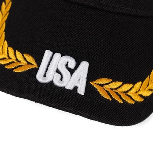 Detail view of high-quality USA embroidery and golden wheat stalks on black cotton cap