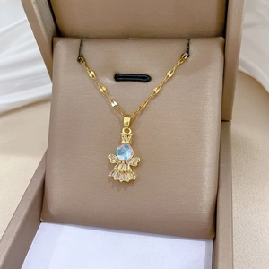 Close-up of golden angel necklace with iridescent blue stone and micro-paved rhinestones