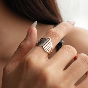 Minimalist silver hollow V-shaped ring with polished finish on model's hand