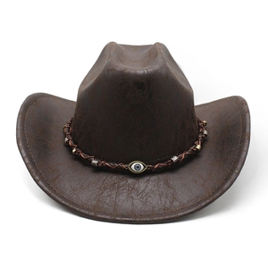 Dettaglio cappello da cowboy con texture screpolata e fascia decorata con malocchio