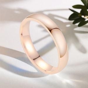 Polished rose gold stainless steel minimalist dome ring with leaf shadows and light