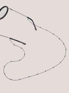 Detail of colorful beads on a black metal eyeglass chain with anti-slip silicone loops