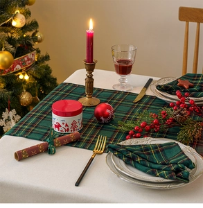 Close-up of green and red plaid table runner and napkin set for Christmas dining