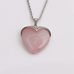 Minimalist pink quartz heart pendant necklace with elegant silver-tone chain on white background