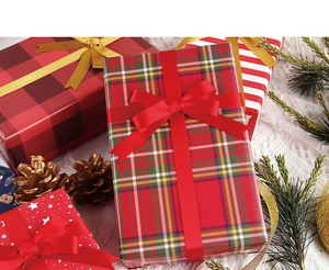 Detail of assorted Christmas gift wrapping papers with plaid, stripes and star patterns