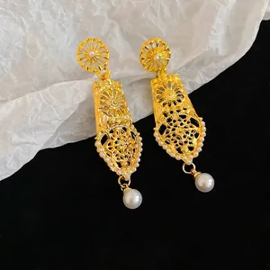 Vintage geometric hollow gold earrings with floral pattern and white teardrop pearls