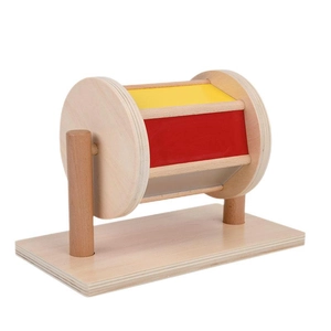 Educational Montessori wooden spinning drum toy with colorful panels on white background
