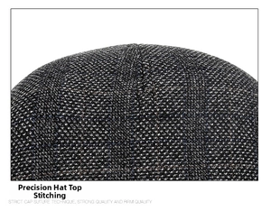 Detailed view of the strict suture technique on the top of plaid wool newsboy cap