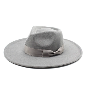 Close-up of gray wide brim felt hat with ribbon bow and textured wool finish