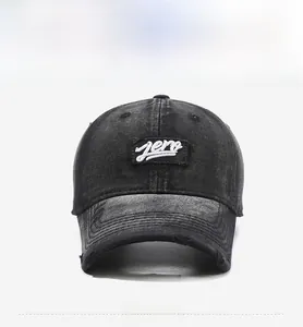 Close-up of zero embroidery and distressed brim on vintage black washed denim cap