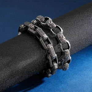 Retro stainless steel men's bracelet featuring Gothic relief patterns and skull charms