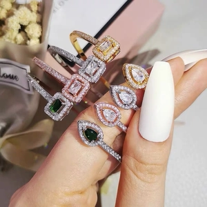 Stackable gold and silver zircon rings featuring emerald and pear cut gemstones