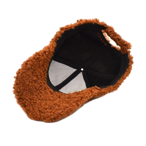 Detail of warm brown teddy fleece baseball cap showing inner lining and stitching
