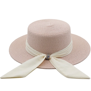 Vintage pink straw sun hat with creamy ribbon and sparkling rhinestone buckle for beach