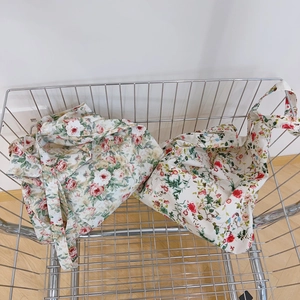 Floral cotton tote bags with pastoral patterns in a minimalist metal shopping cart