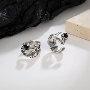 Macro shot of vintage silver ear cuff showing black zircon stone and S925 engraved texture