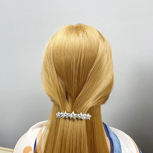 Silver star spring hair clip shown on blonde hair for a minimalist back-of-head hairstyle