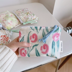 Detailed view of floral cotton mini pouch with red tulips and blue zipper pull cord