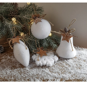 Detail of four white foam Christmas ornaments including ball, heart, snowflake, and bell shapes