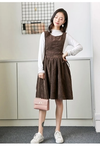 Close-up of the fine texture on this brown corduroy pinafore dress with a side bow detail