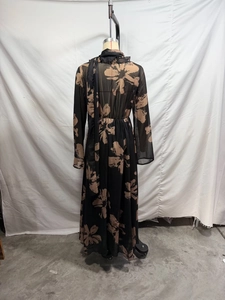 Detail of high waist pleated chiffon maxi dress with vintage floral print and long sleeves