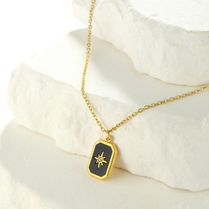 Minimalist gold plated stainless steel necklace with black zircon star pendant on rock