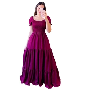 Detail of magenta tiered maxi dress showing smocked chest and puff sleeves