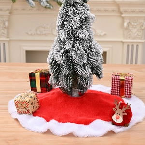 Mini plush red and white Christmas tree skirt with festive gift boxes and decor
