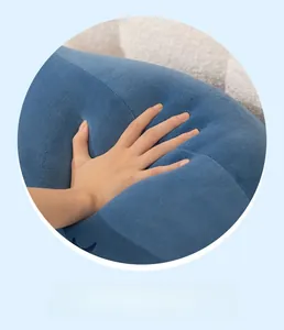 Detail of high-elasticity dark blue plush pillow showing slow rebound after hand pressure