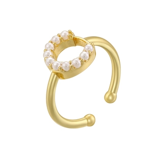 Close-up of golden ring with circular pearl inlay and luxury metallic finish detail