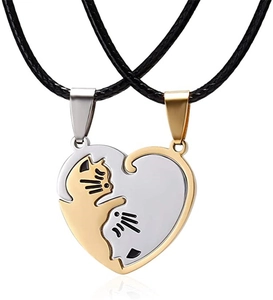 Close-up of cat heart pendant set in gold and silver finish with black wax cords