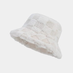 Close-up of fluffy white checkered bucket hat with thick plush texture and embossed pattern
