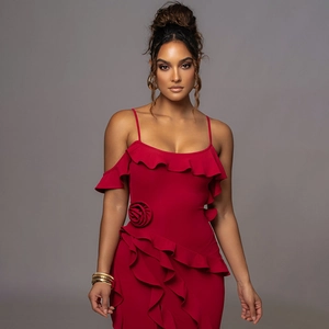 Detail of red off-shoulder dress featuring elegant ruffles and 3D floral accents on the fabric