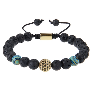 Macro detail of lava stone beads and gold zircon pave ball on braided cord bracelet