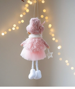 Detailed view of plush pink Christmas angel doll with woolly sweater and tutu skirt
